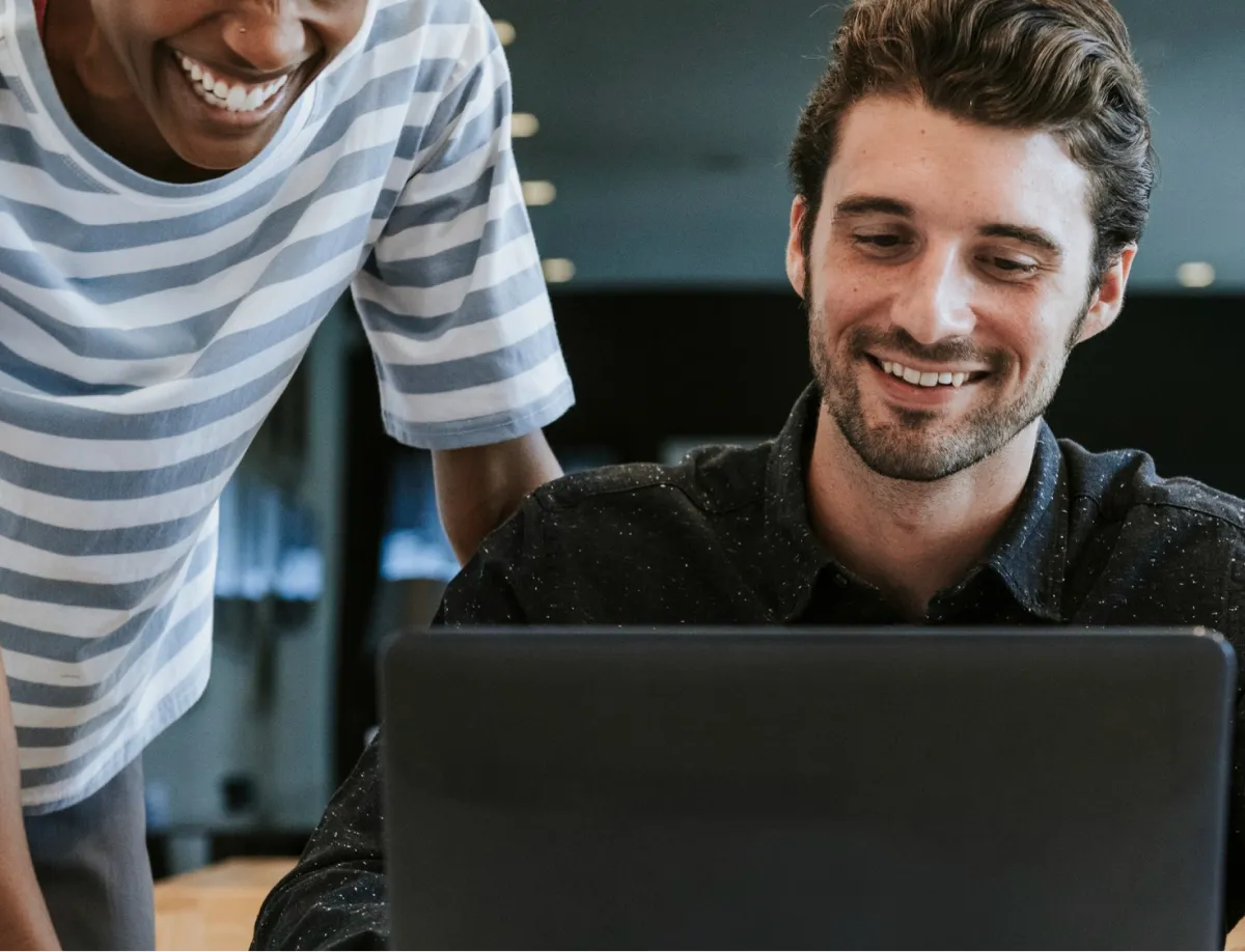 Two colleagues working at the same computer