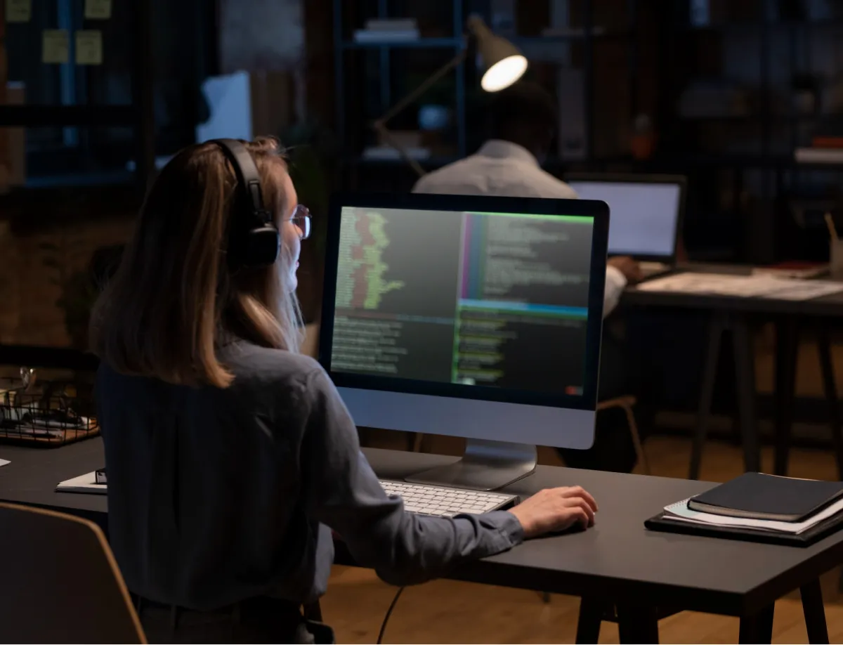 Woman sitting at a desk writing code