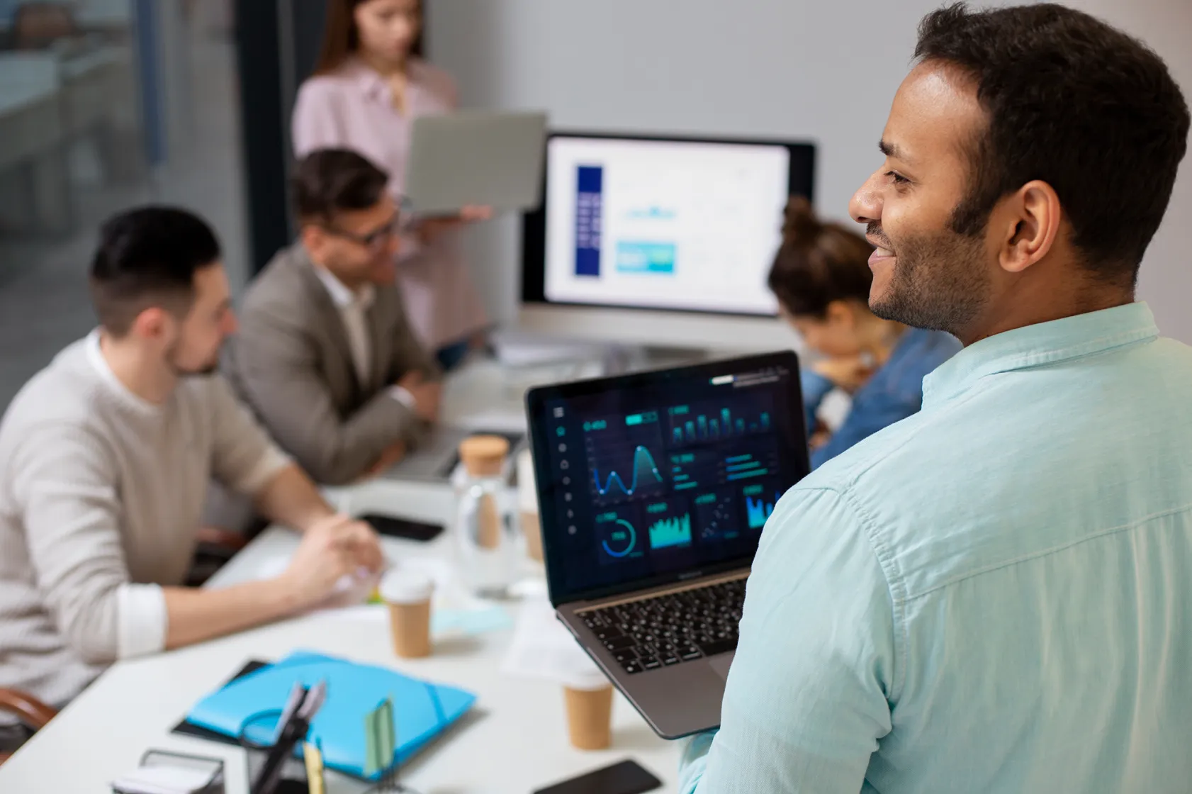 Man and his team at work with computers